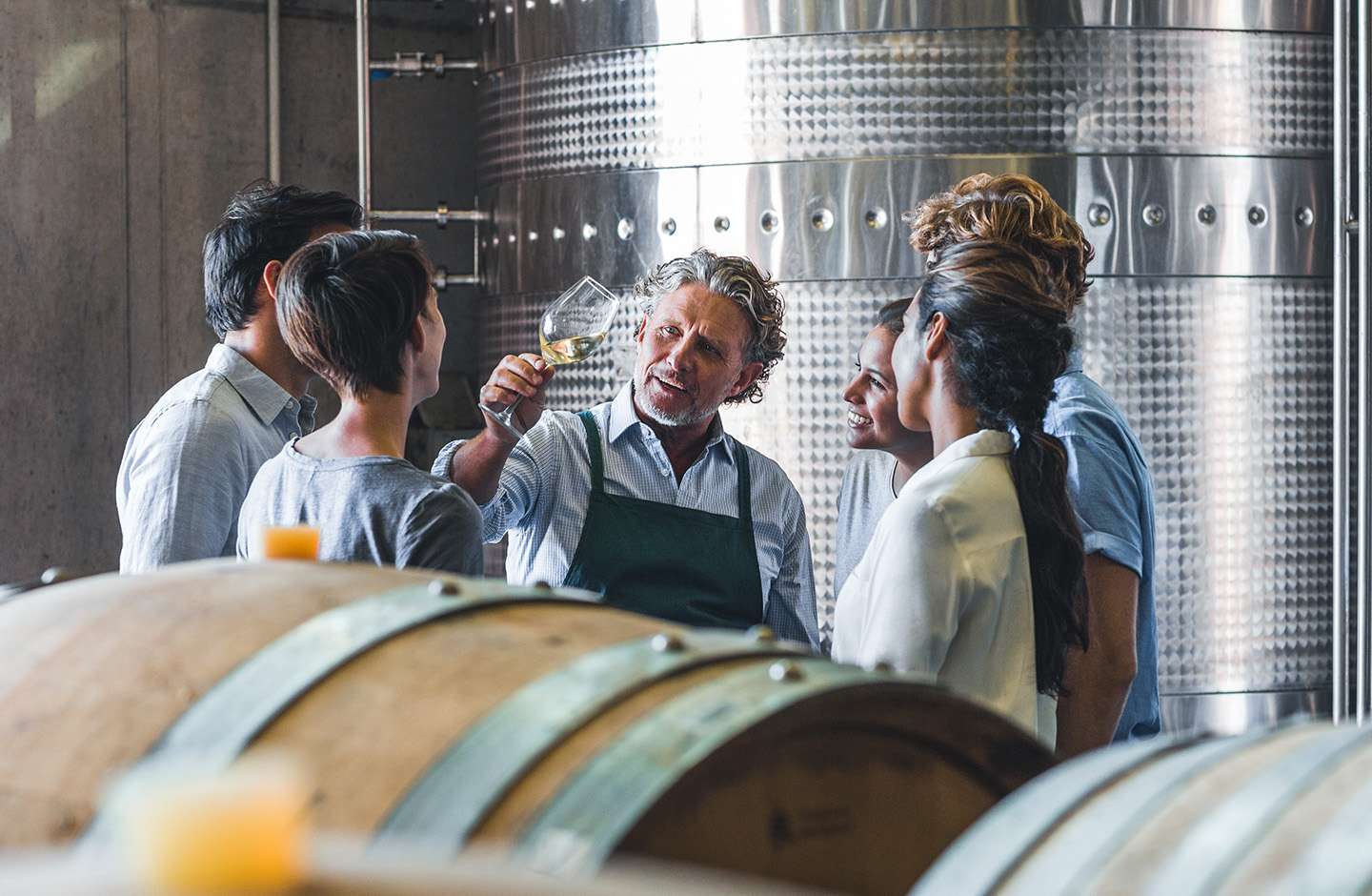 winemaker tasting wine in cellar
